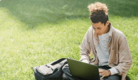 Student working on laptop outdoors